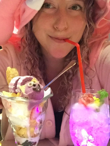 Author Jess in a costume drinking glowing drinks