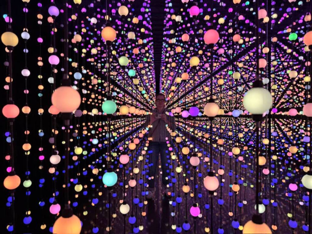 Author Jill taking a photo at the infinity lights exhibition in Hopscotch San Antonio