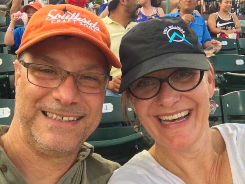 Author Jill and her husband enjoying the Missions game