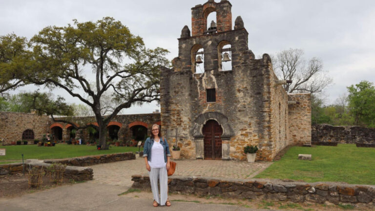 Author Jill standing in front of Mission Espada in San Antonio Missions National Historical Park