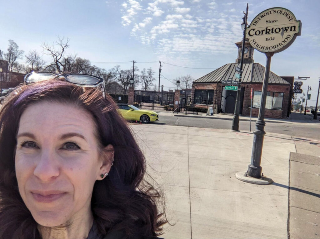 Author Julie taking a selfie with the Corktown sign