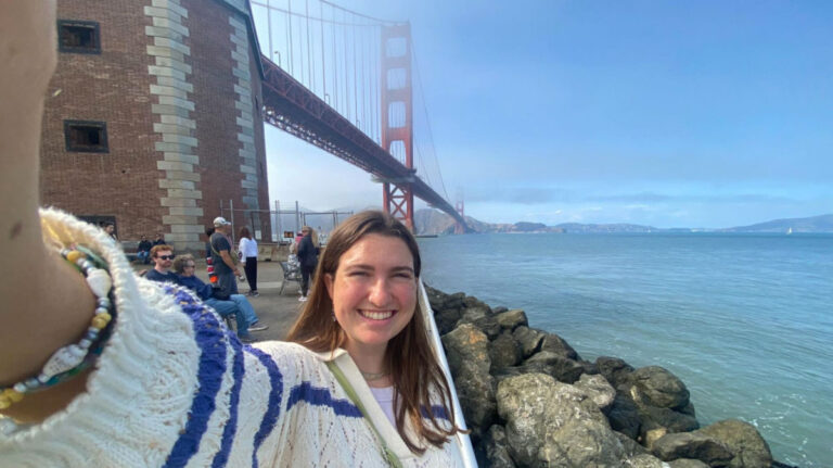 Author Laura McFarland standing in front of the Golden Gate Bridge