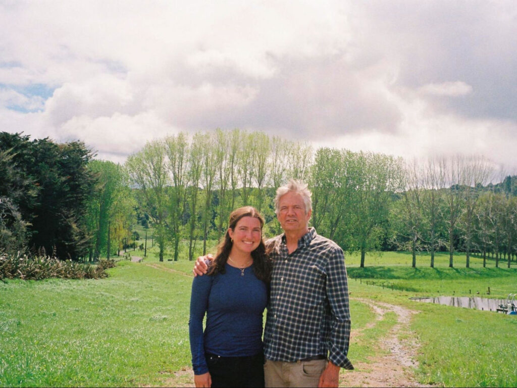 Author Laura and her dad posing for a photo on the old farm in New Zealand