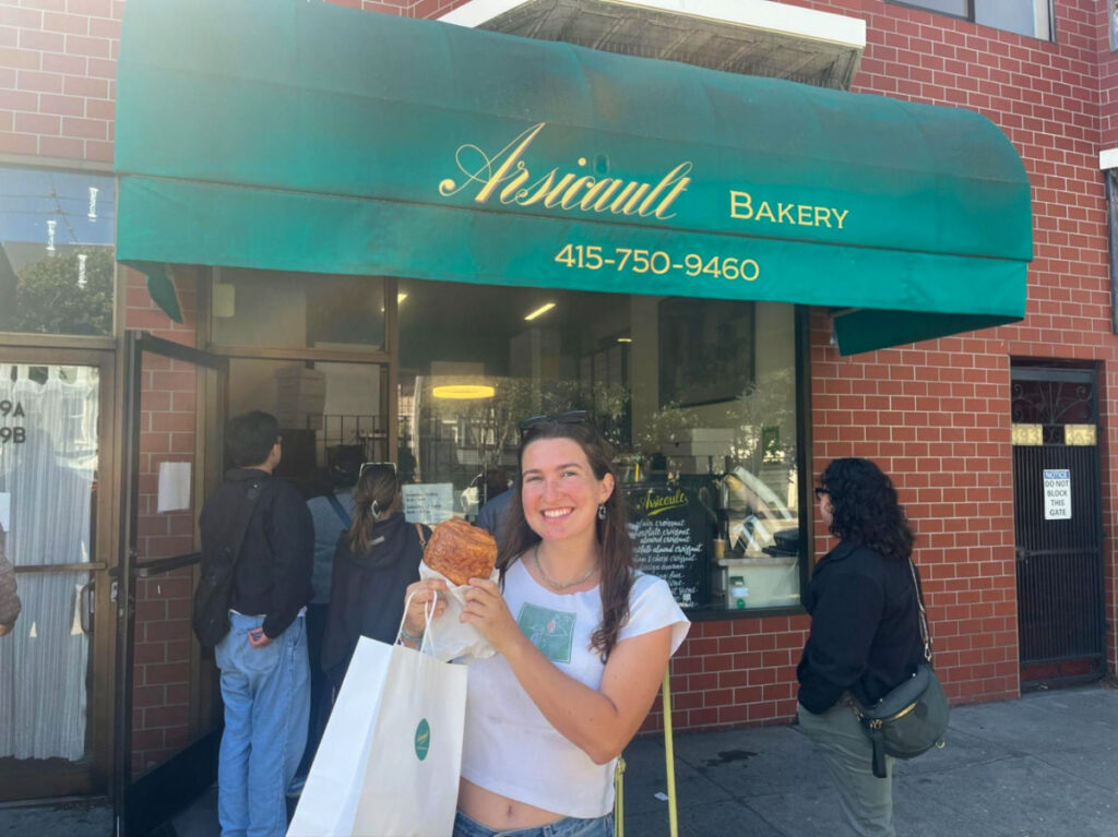 Author Laura holding a croissant at Arsicault Bakery