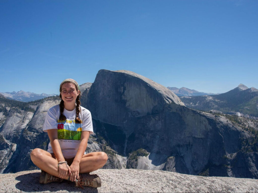 Author Laura sitting at the top of North Dome, across from Half Dome
