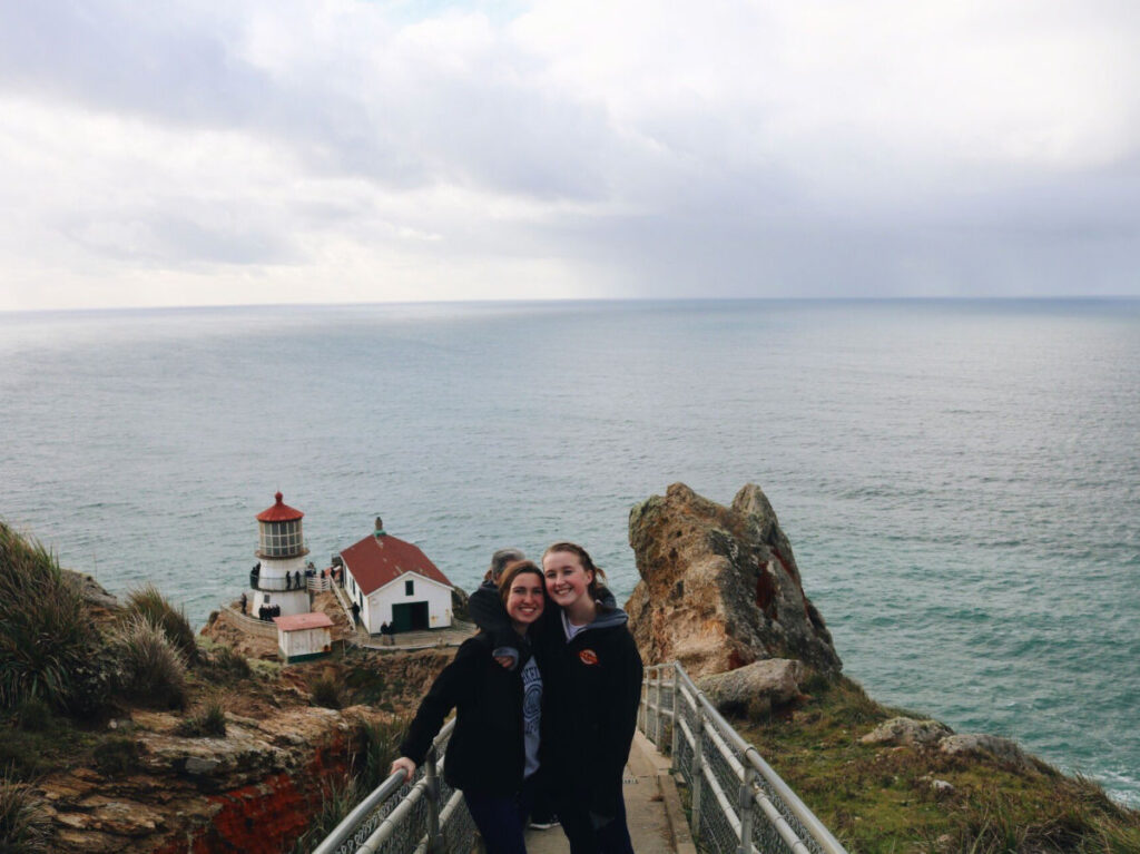 Author Laura and her friend taking a photo at Point Reyes Lighthouse