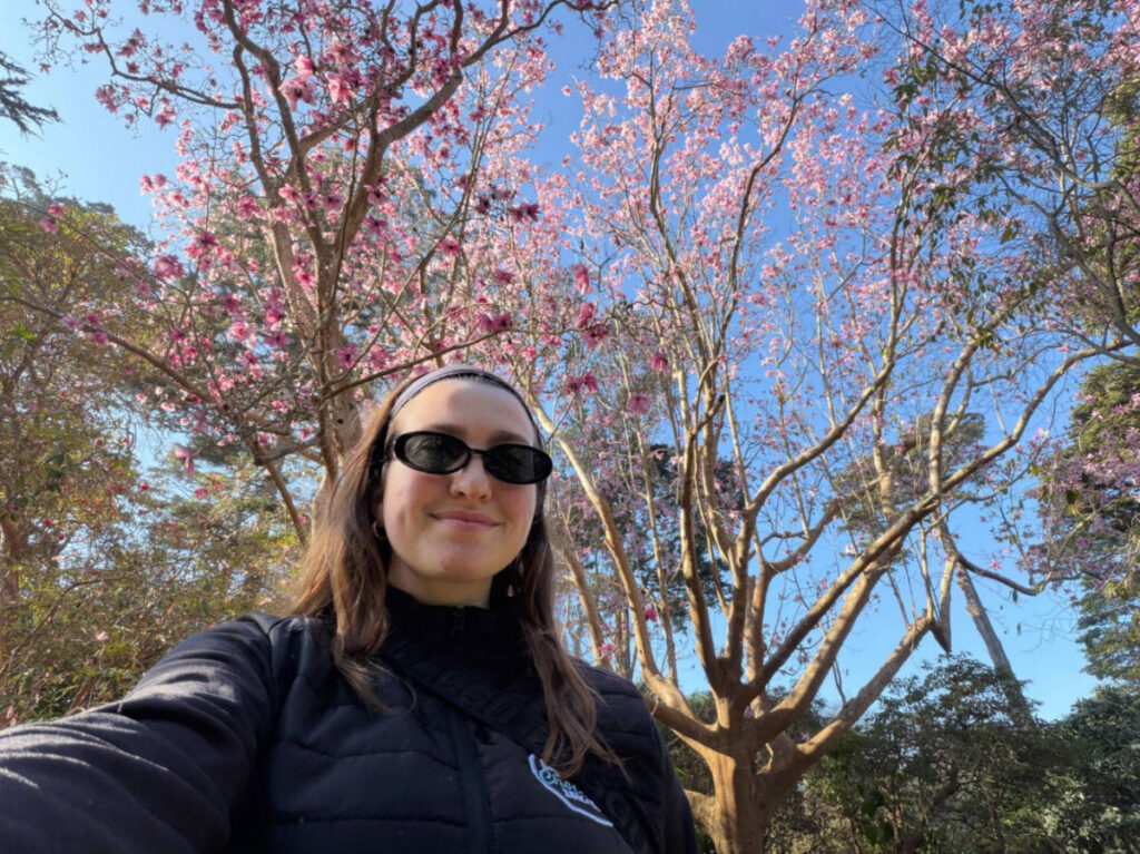 Author Laura standing underneath one of the magnolia trees in the SF Botanical Garden