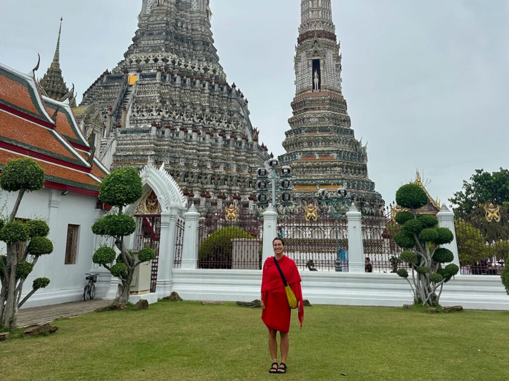 Author Laura covered in red clothes at Wat Arun temple