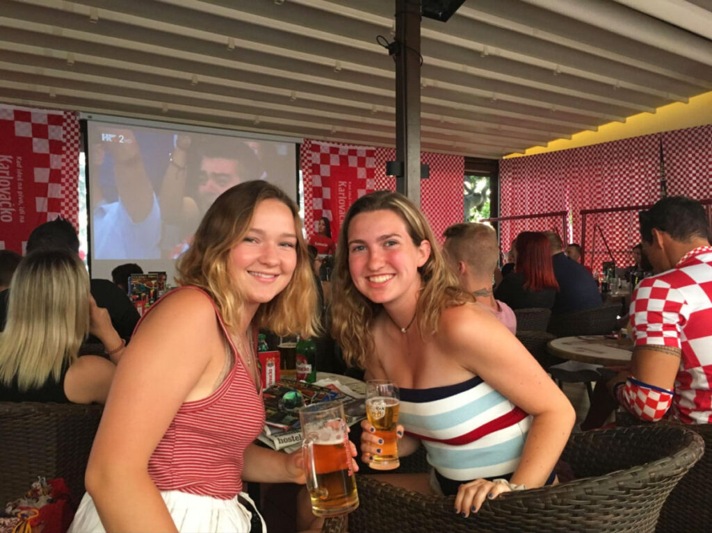 Author Laura and her friend drinking beers in Biograd Na Moru while watching the 2018 World Cup