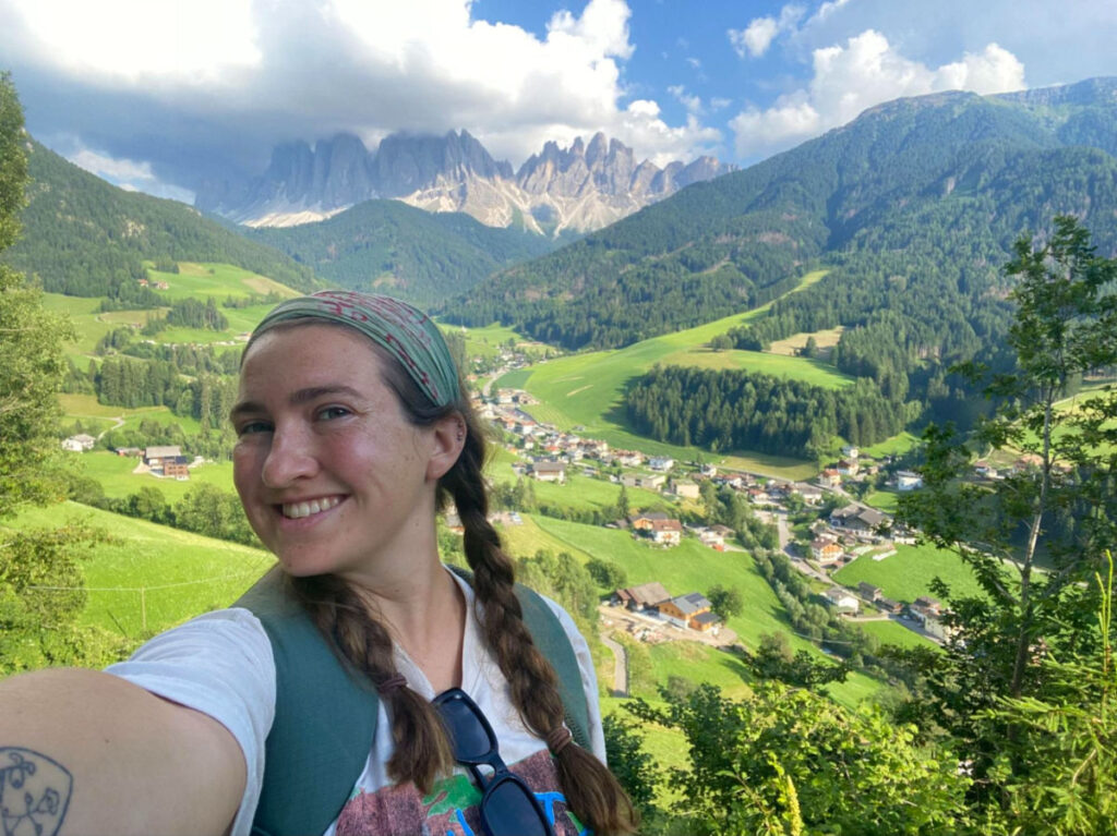 Author Laura taking a selfie while hiking in the Dolomites in Northern Italy