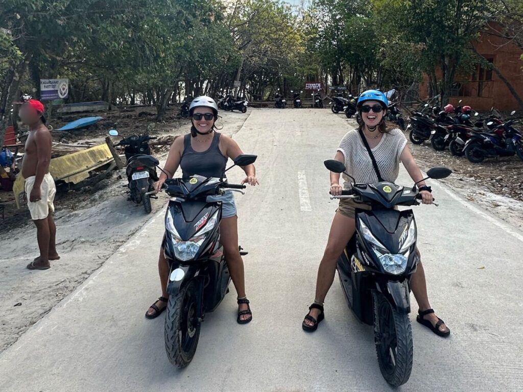 Author Laura and her partner riding motorbikes on the island of Siquijor in the Philippines