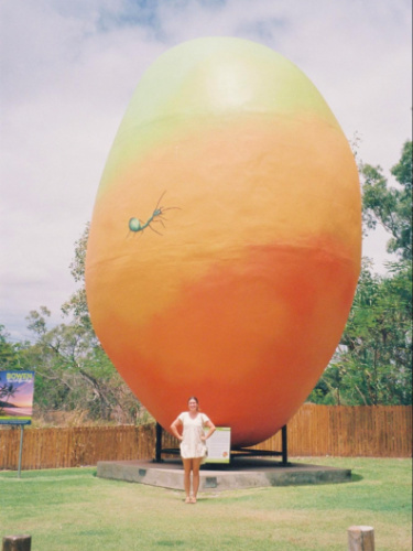 Author Laura poses in front of a giant mango