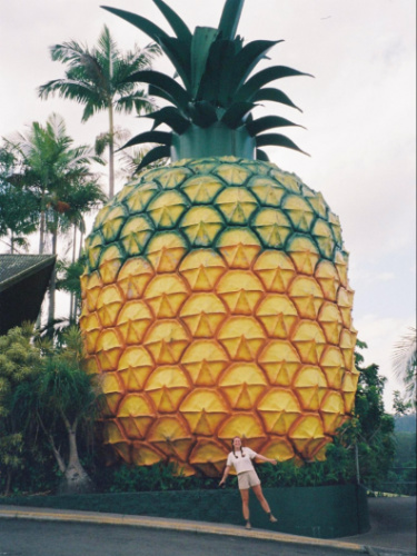 Author Laura poses in front of a giant pineapple