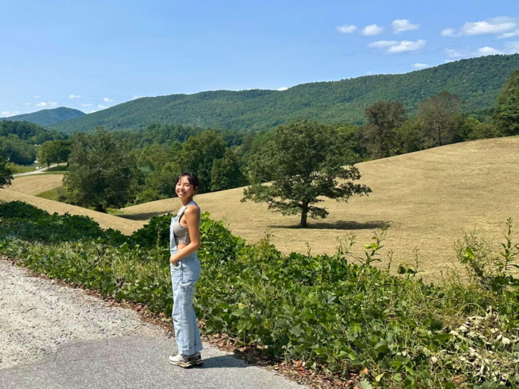 Author Lea Rose standing at a beautiful landscape in Western North Carolina
