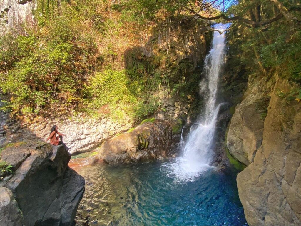 Author Lia looking at the  Kawazu Nanadaru Waterfalls