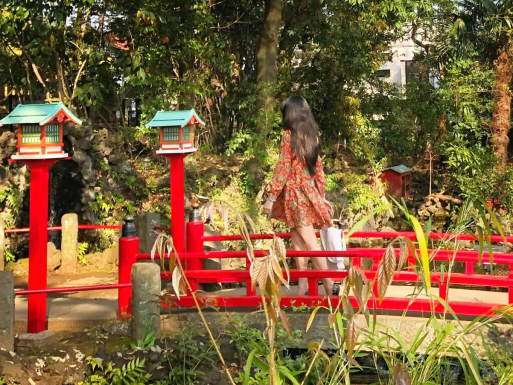 Author Lia walking over the bridge at Setagaya Hachimangu Shrine