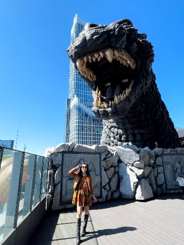 Author Lia taking a picture with the Shinjuku godzilla