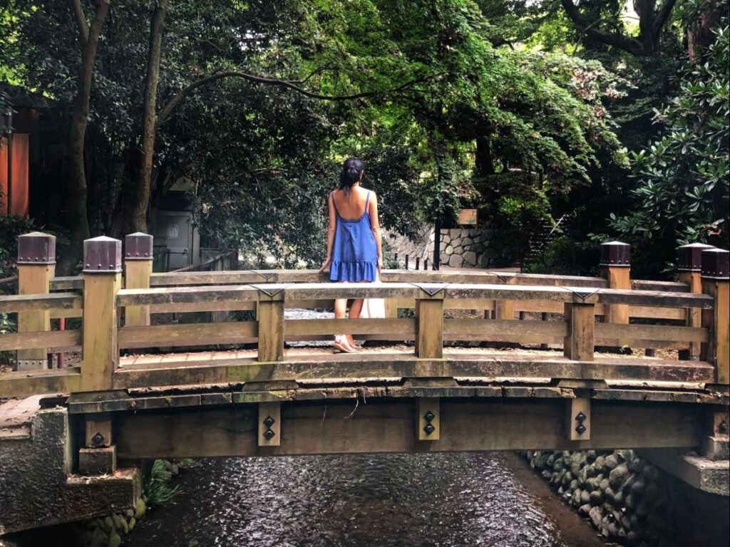 Author Lia standing on the wooden bridge in Todoroki Valley