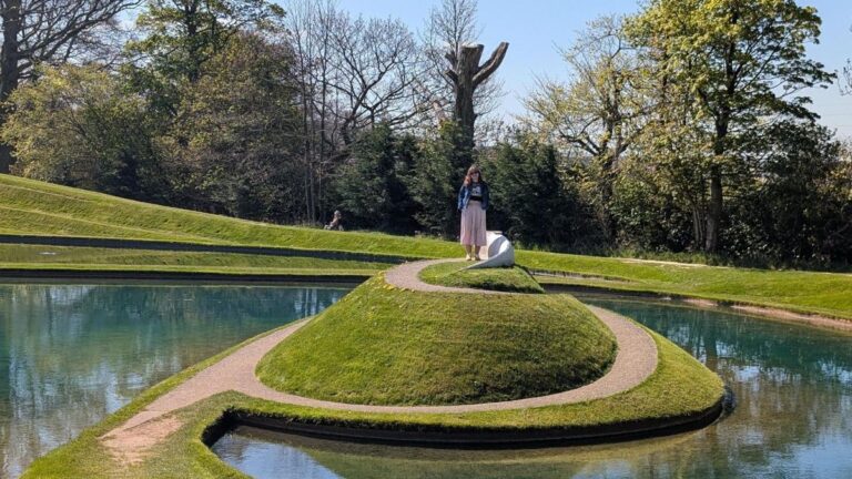 Author Louise standing on one of the artworks at Jupiter Artland