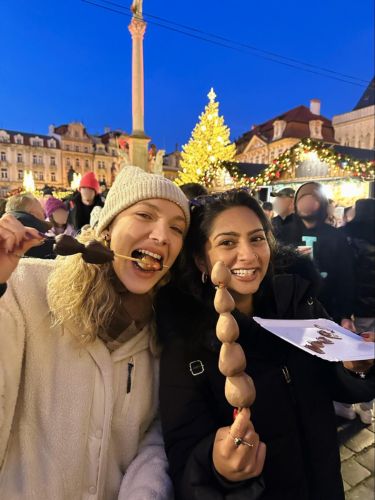 Author Meera and her friend enjoying the street food at the Christmas Market