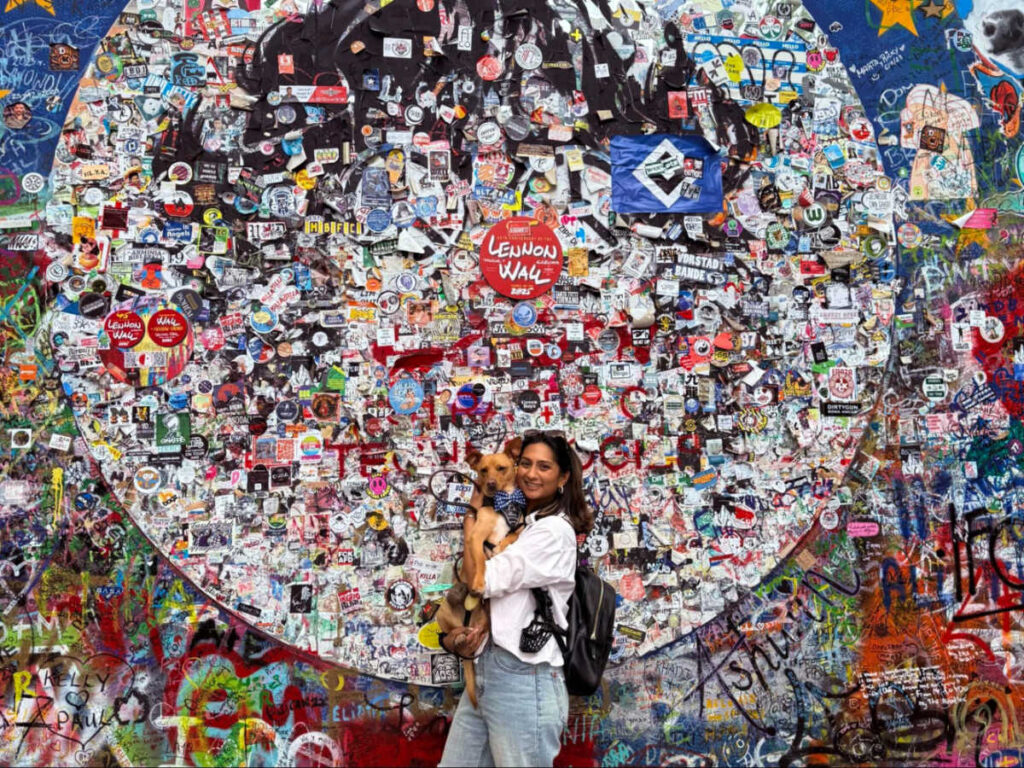Author Meera and her pet dog visiting the Lennon Wall