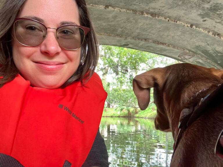 Author Meg and her dog riding a boat