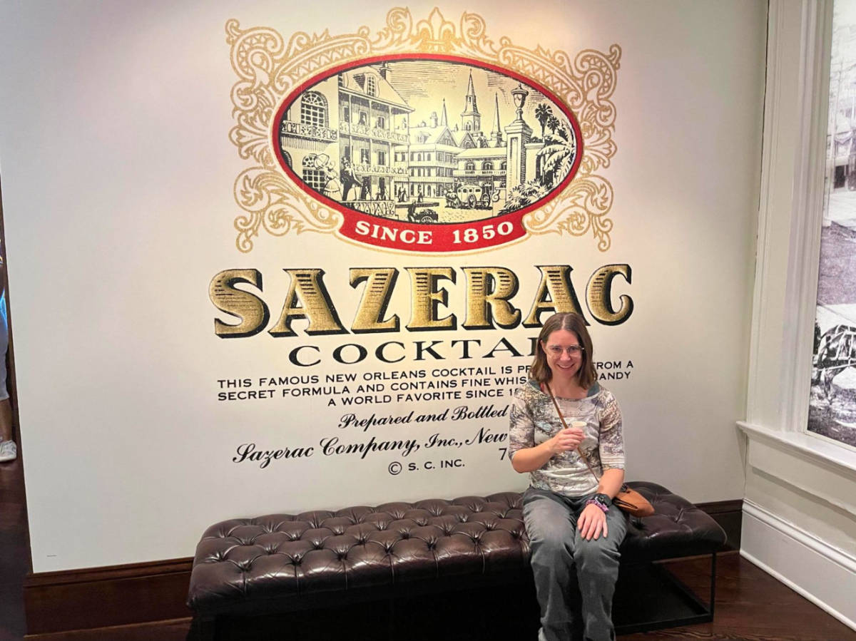 Author Meg with a sample cocktail at the Sazerac House