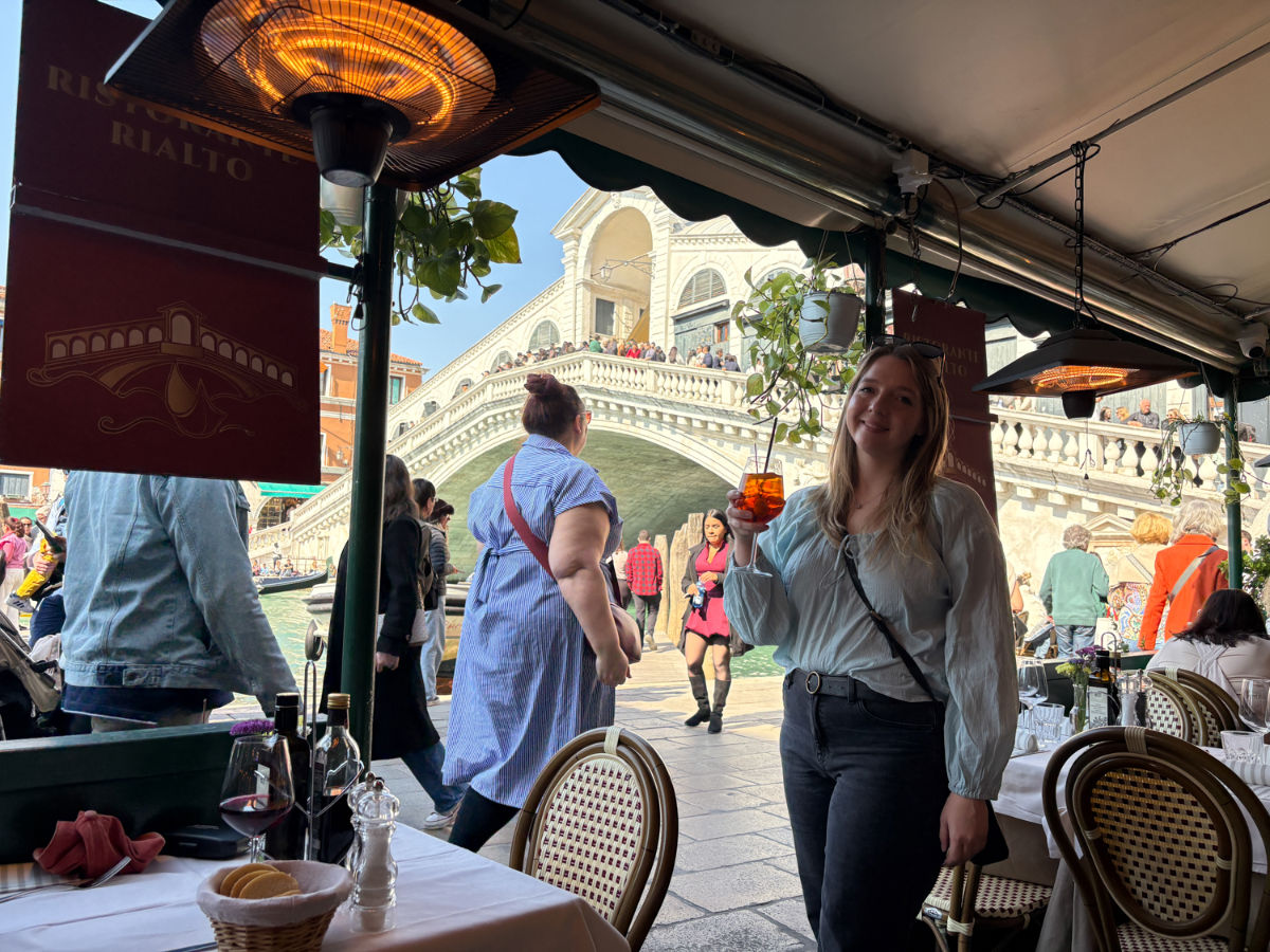 Author Taylor enjoying a drink at Ristorante Rialto with a view of Rialto Bridge at the background