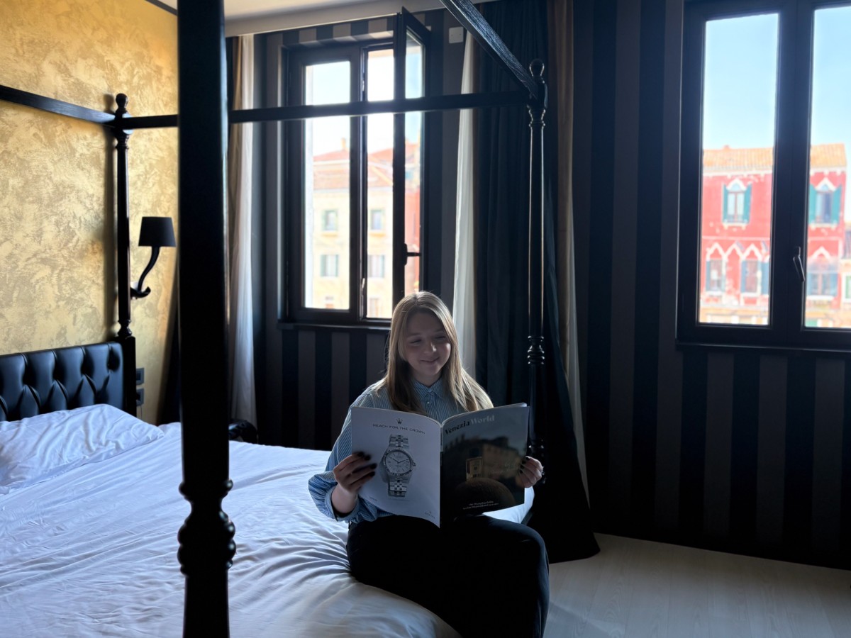 Author Taylor reading a magazine while in the Carnival Palace suite