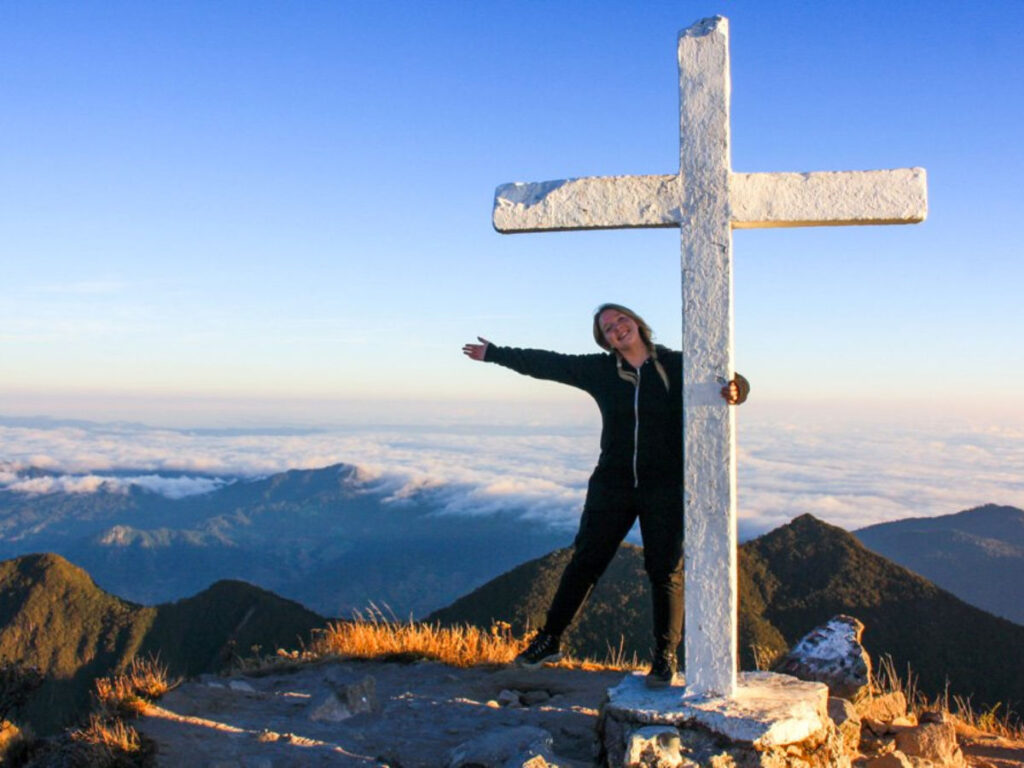 Author Taylor posing with the cross at the summit of Volcan Baru