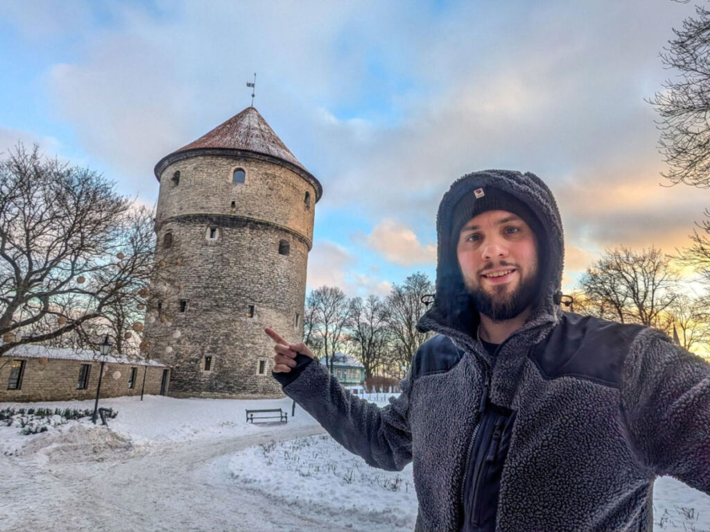 Author Thom standing outside and pointing to the Kiek in de Kök tower
