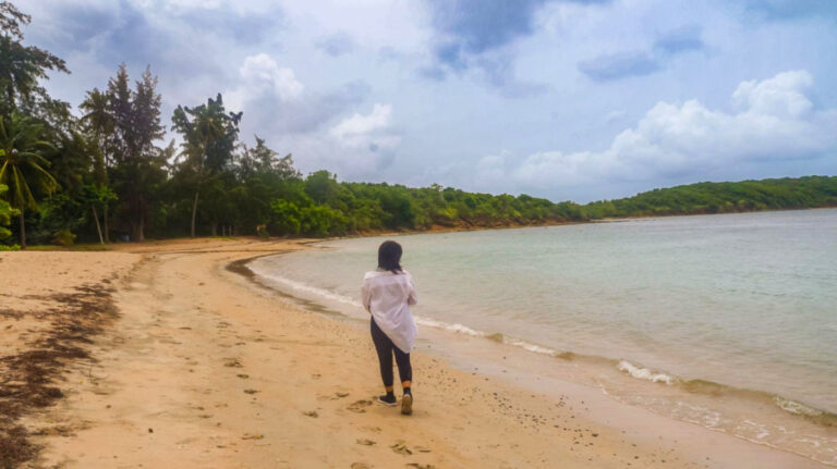 Author Vanessa walking along the coast of Seven Seas