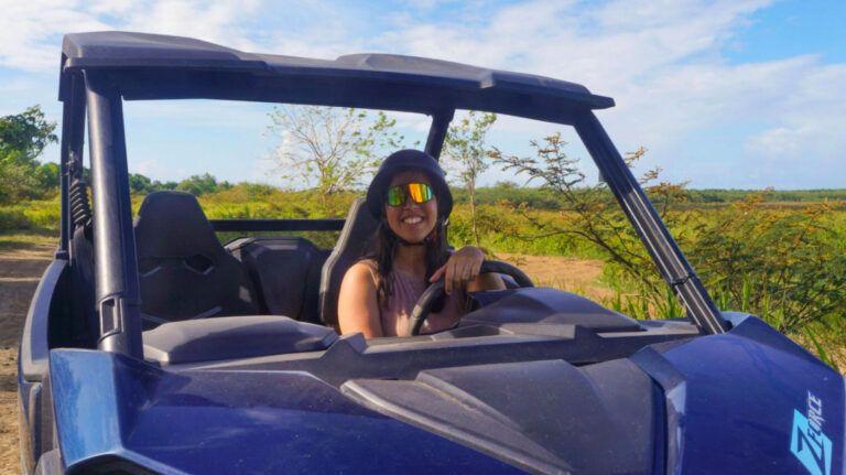 Author Vanessa driving a blue UTV