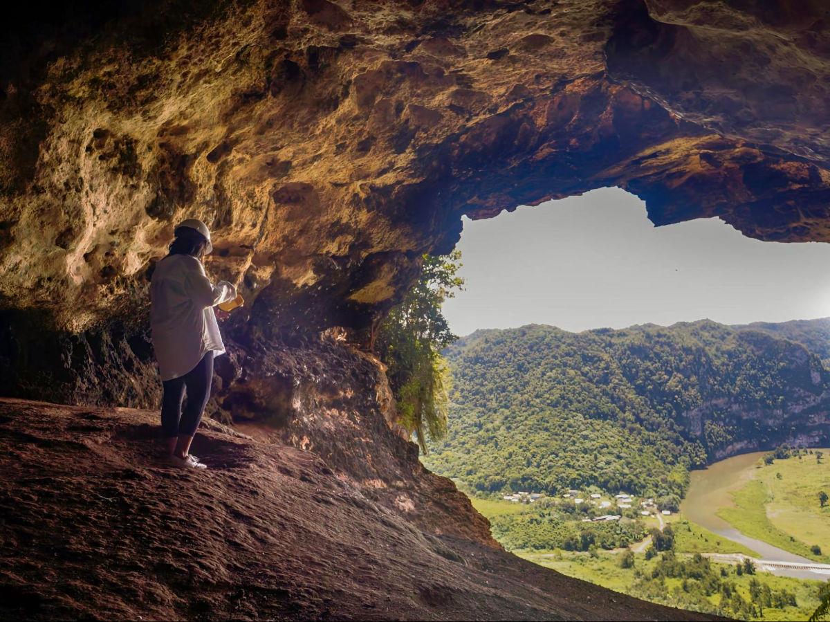 Author Vanessa standing in Cueva Ventana and admiring the view below