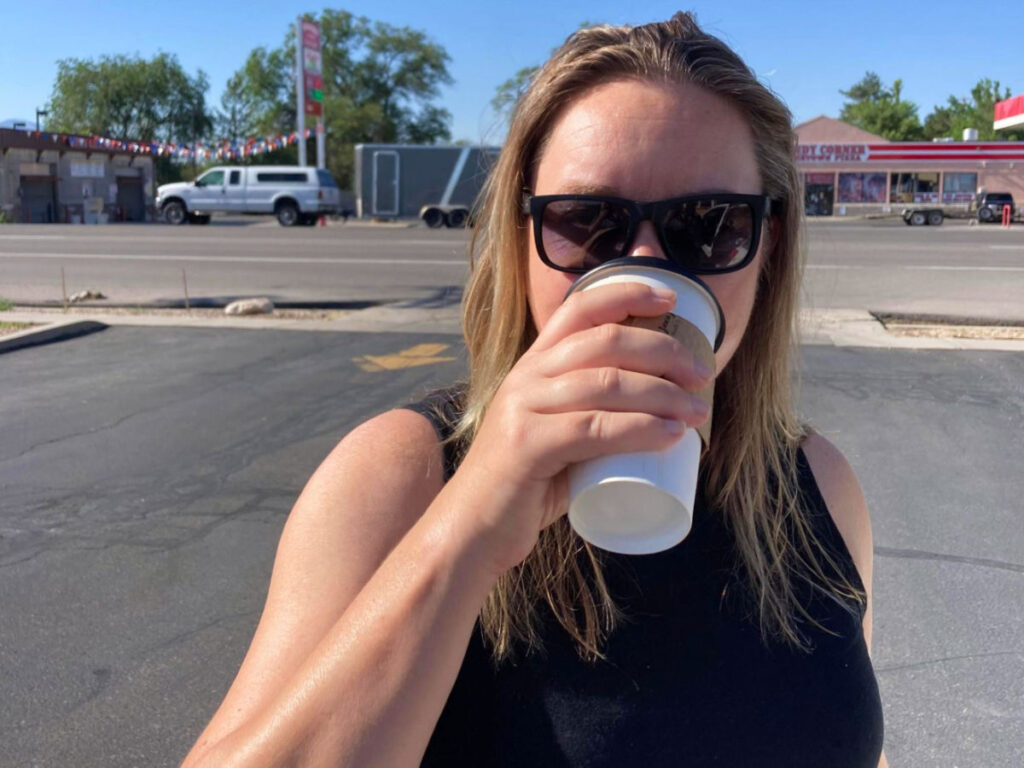Author Laura Falin drinking a cup of coffee in Grantsville