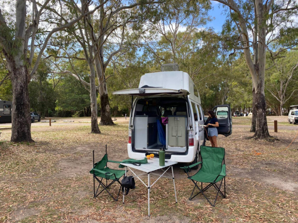 Tables and chairs setup at the back of the campervan