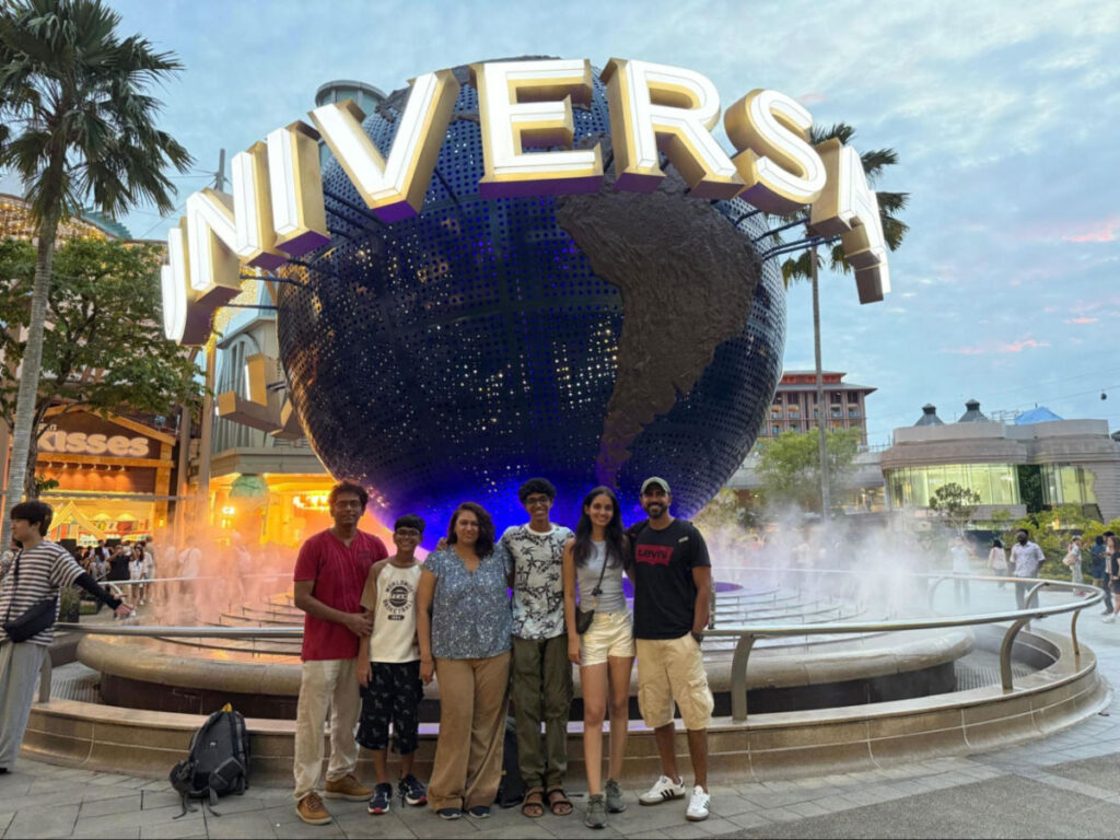 Author Advaita and her family taking photo at the famous globe at Universal Studios