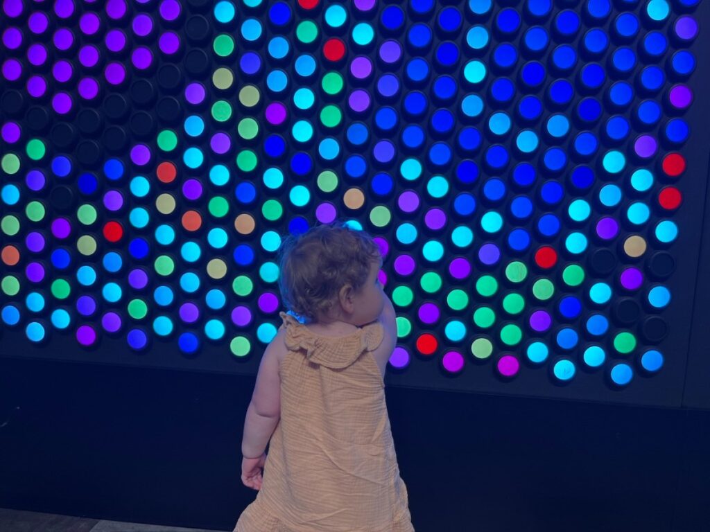 Author's toddler playing at the light wall