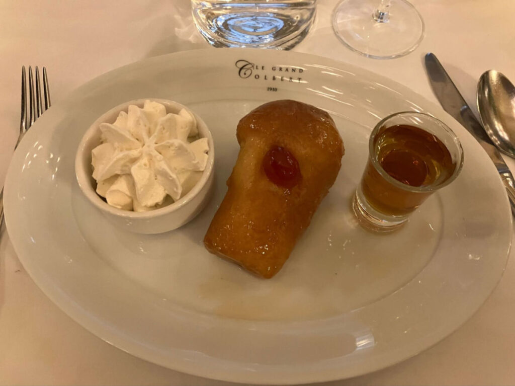 A plate of Baba au Rhum at Le Grand Colbert restaurant
