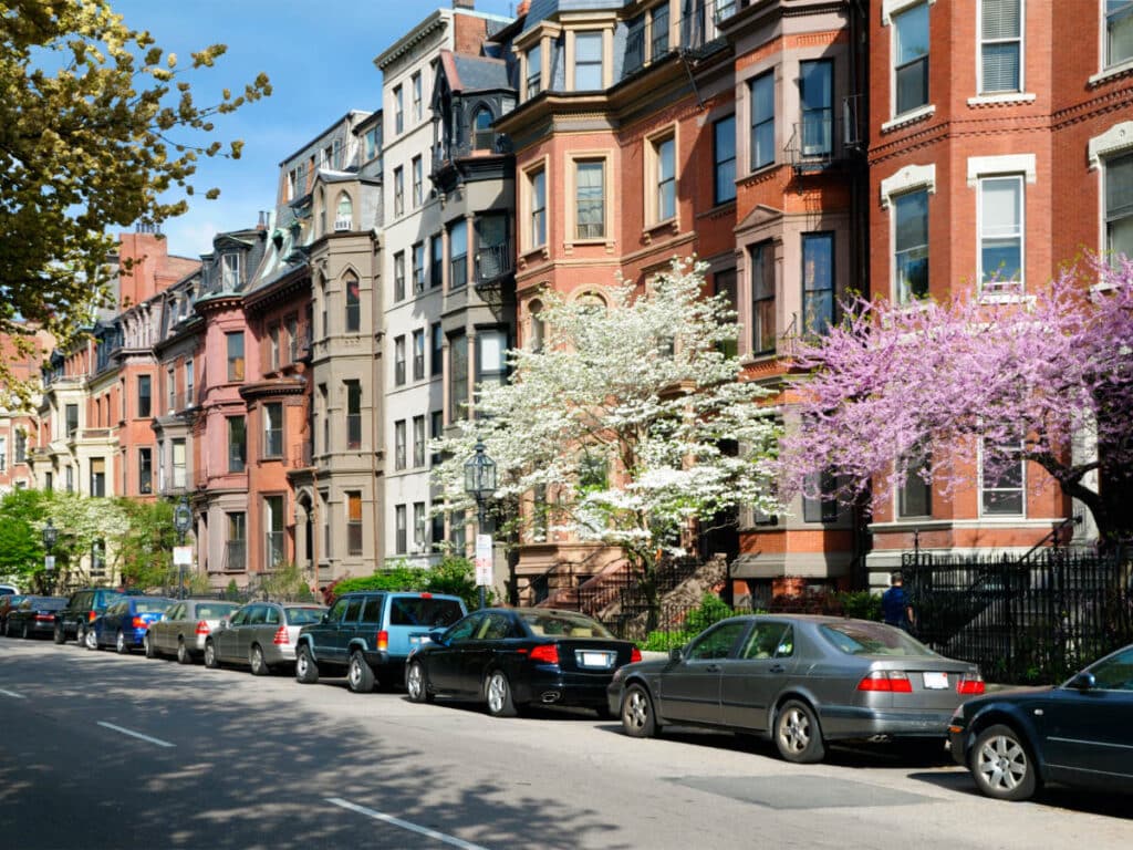 Cars parked on the side of a street on a residential area in Back Bay