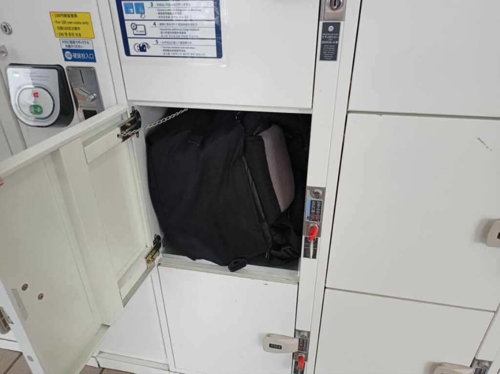 A backpack in a coin locker at a train station