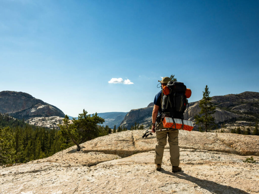 A backpacker admiring the scenic view in Yosemite