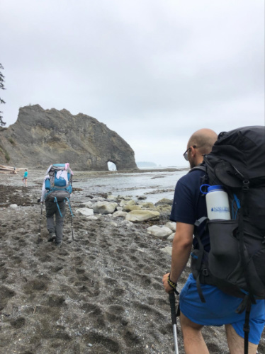 People backpacking along the coast in Rialto Beach