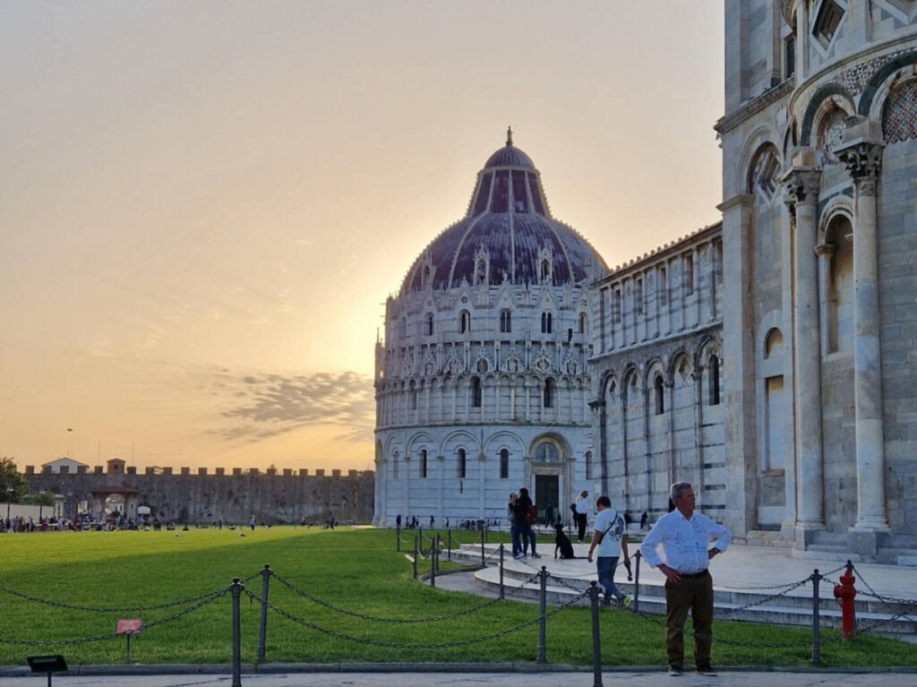 The intricate exterior of Baptistery of Piazza dei Miracoli at sunset