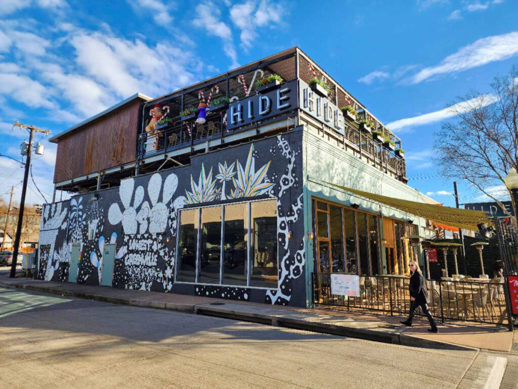 Sarah Heath walking in front of Hide bar in Lower Greenville, Dallas