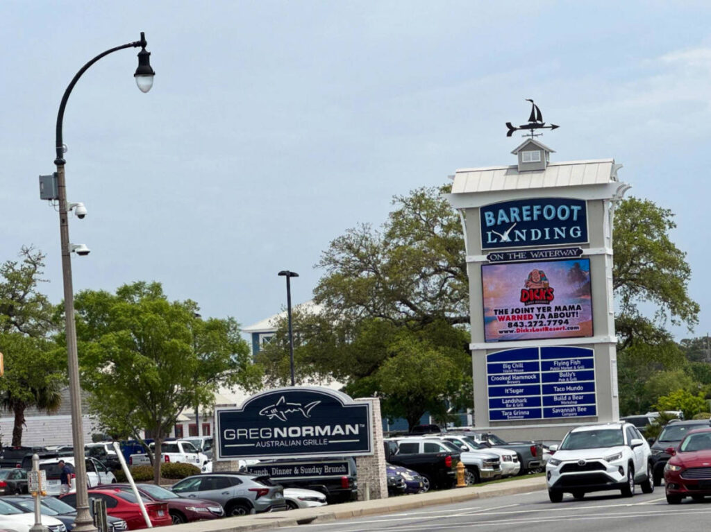 View of the Barefoot Landing sign at the parking area