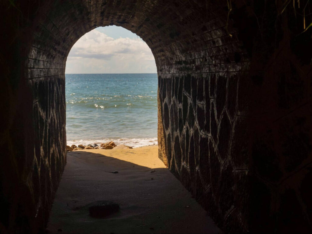 View of the stunning beach from the archway of Barrero’s Tunnel