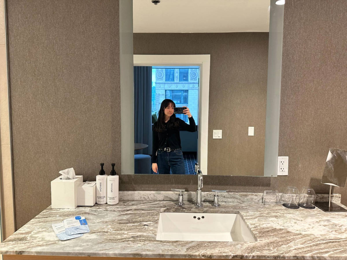 The author, Lea Rose Allbaugh smiling for a mirror selfie