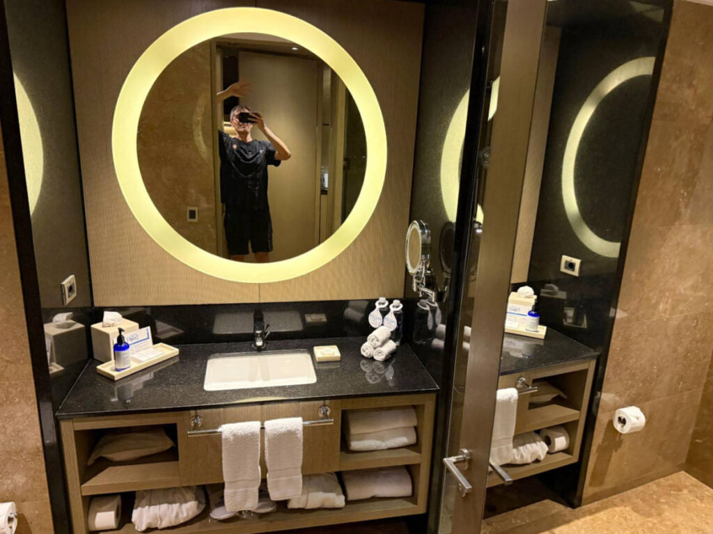 The author, Nate Hake posing for a mirror selfie on their bathroom at Hilton Lima Miraflores