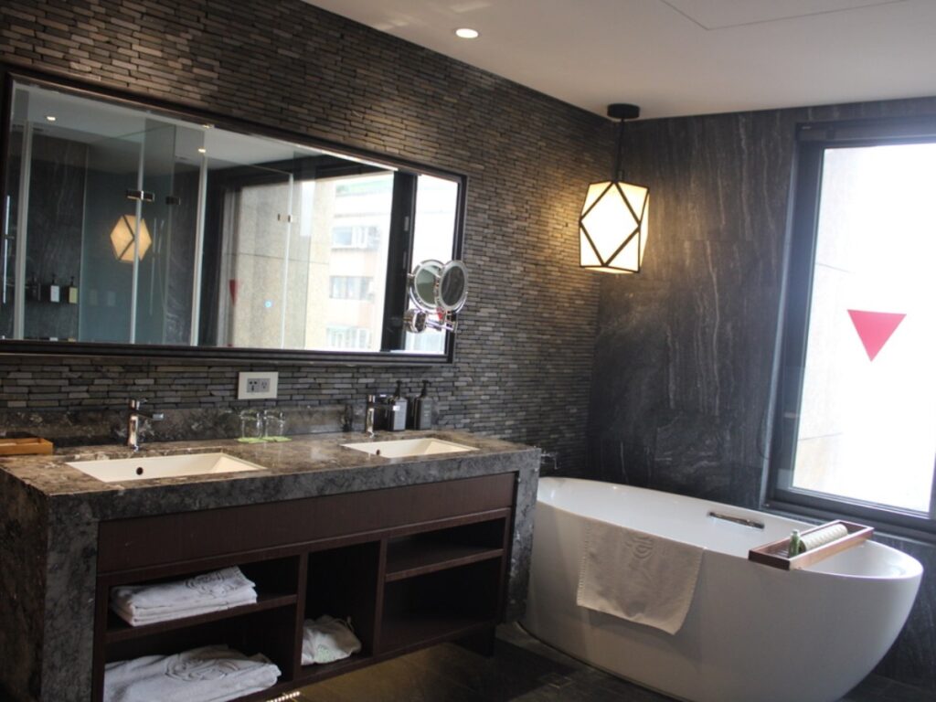 View of the mirrors and bathtub area at arTree Hotel